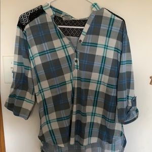 It is a blue and black plad half button  shirt